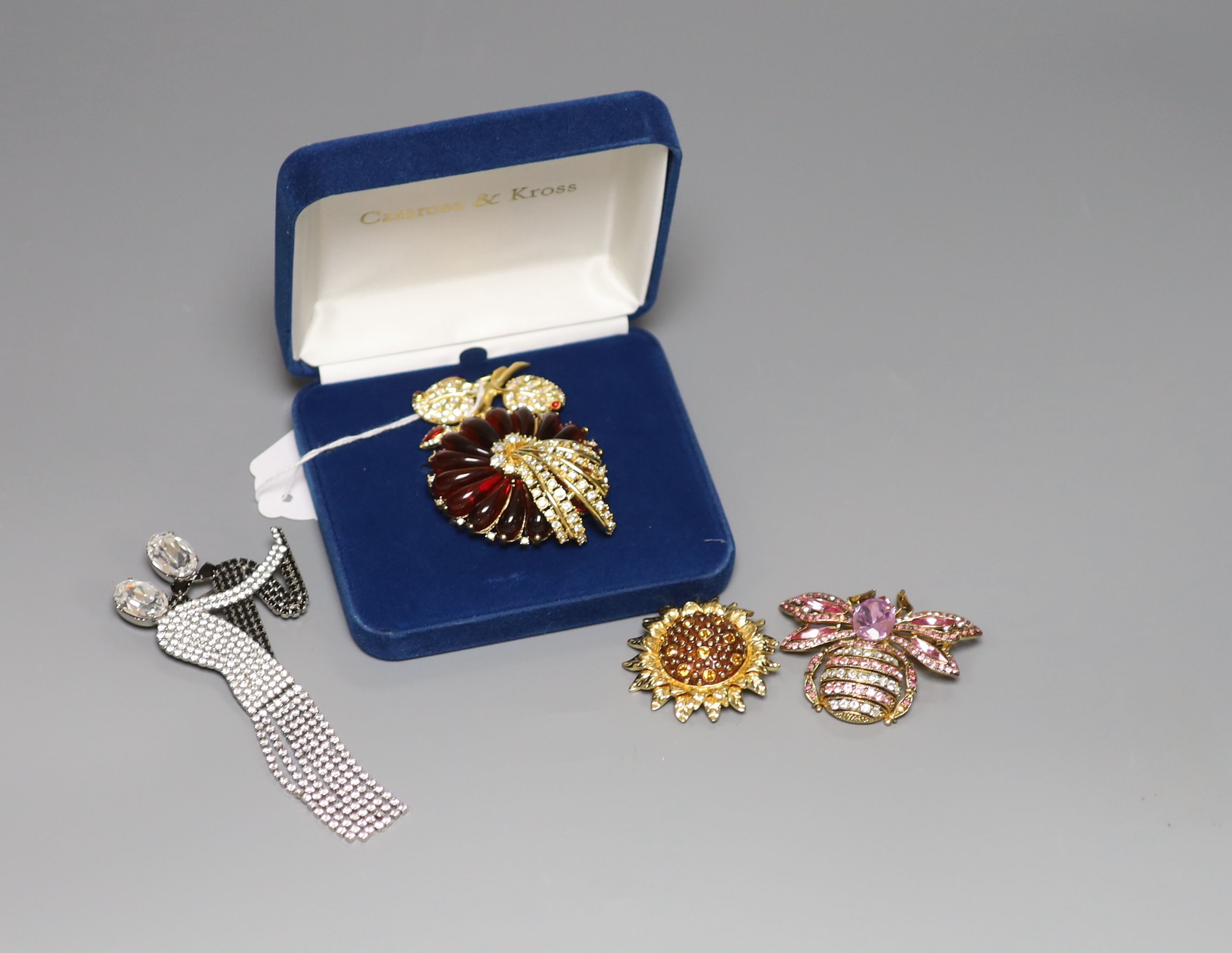 Four items of designer costume jewellery, including a Camrose & Kross 'Jacqueline Kennedy' reproduction flower brooch